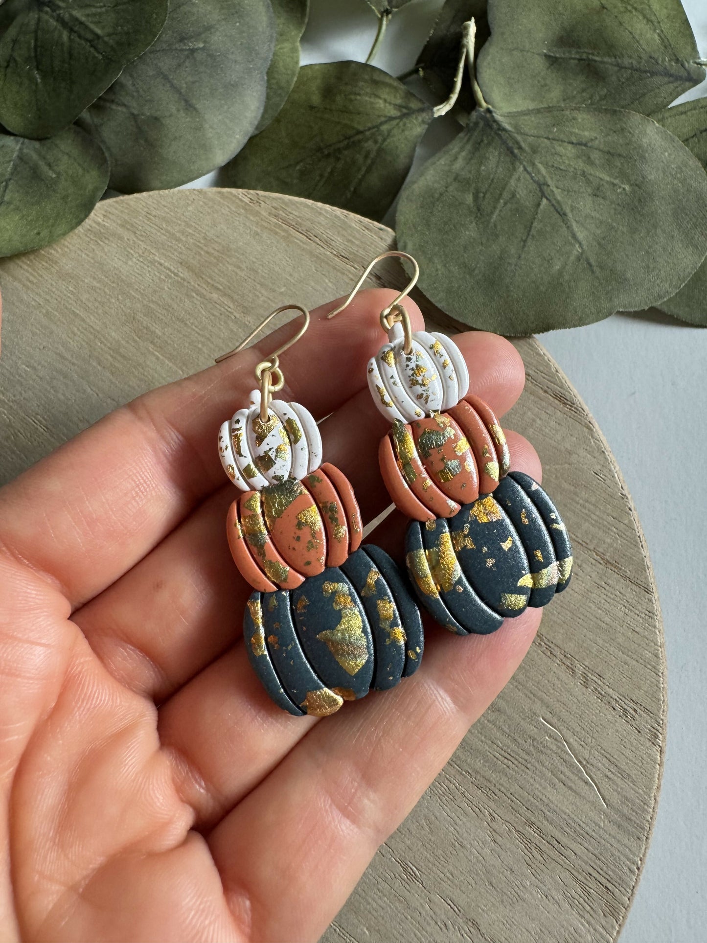 Stack of pumpkin earrings with metallic accent
