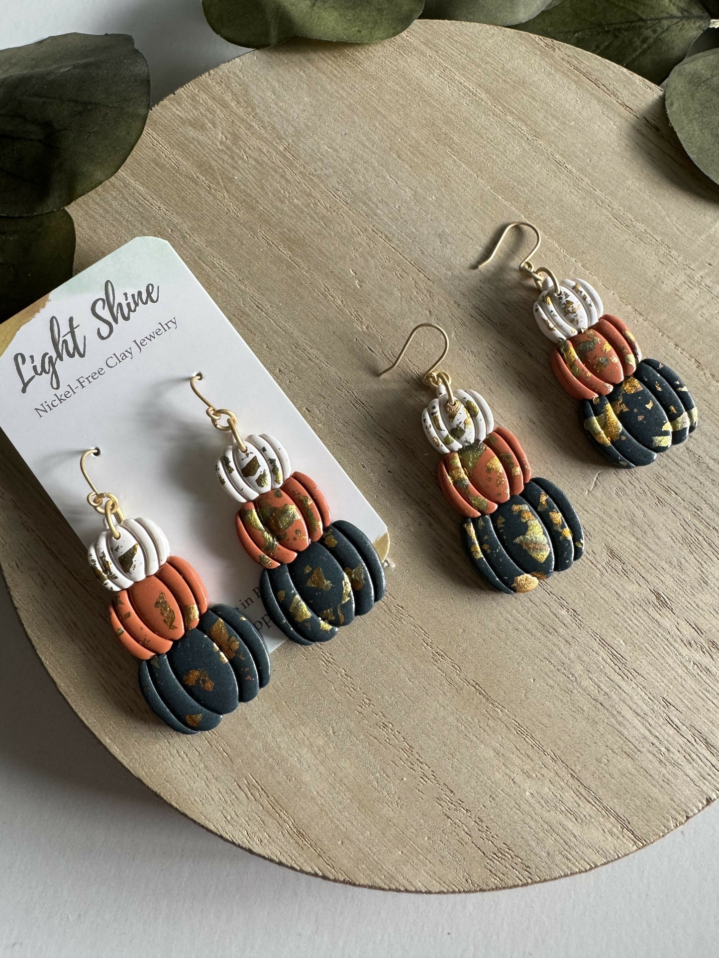 Stack of pumpkin earrings with metallic accent