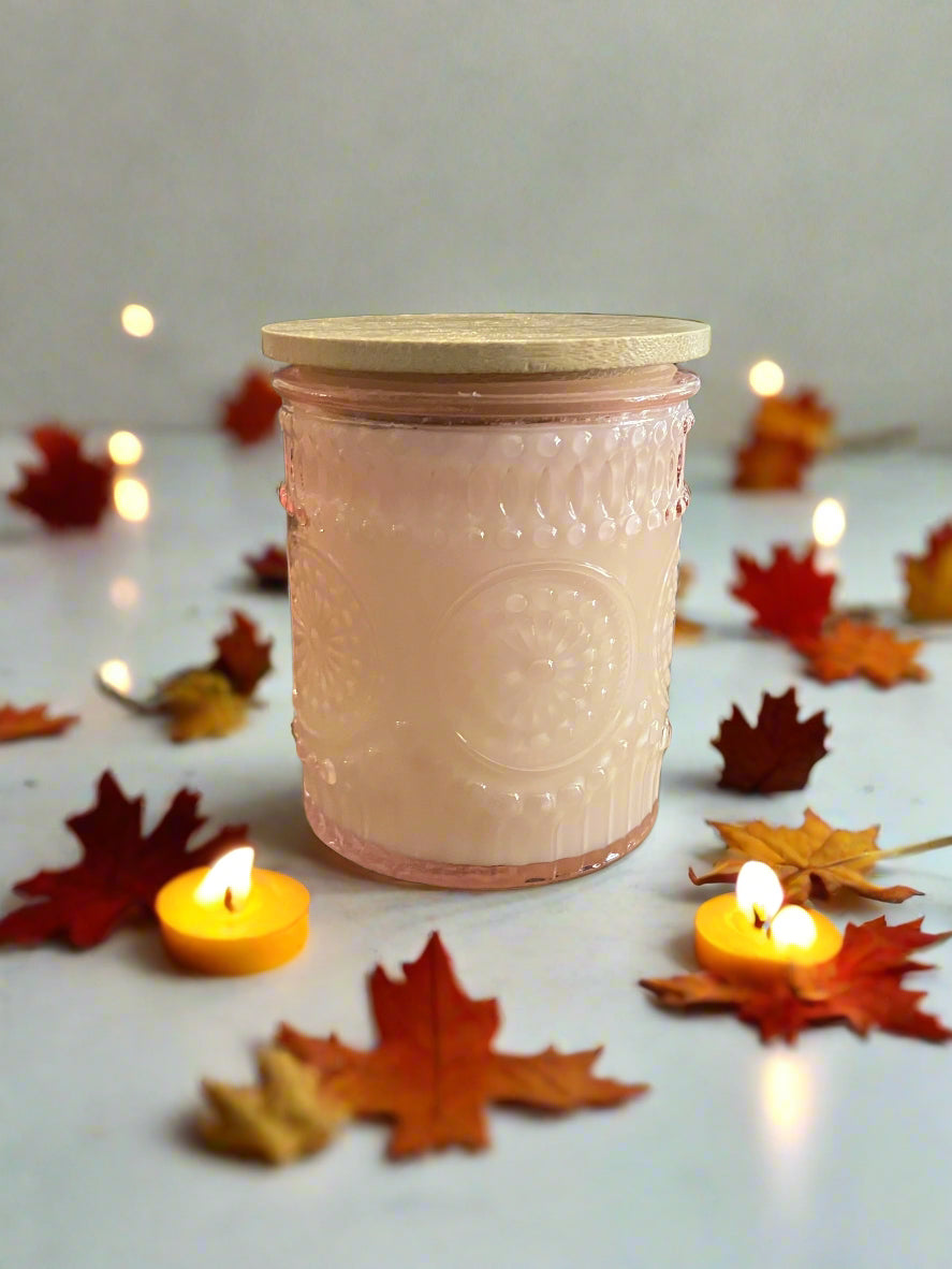 Pink textured cylindrical object on a wooden surface with a tablet in the background