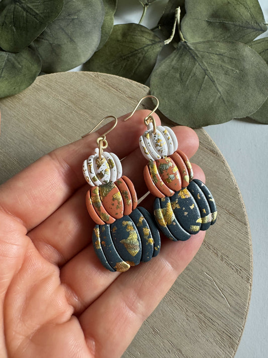 Stack of pumpkin earrings with metallic accent