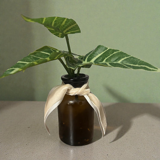 Faux Plant In Amber Vase